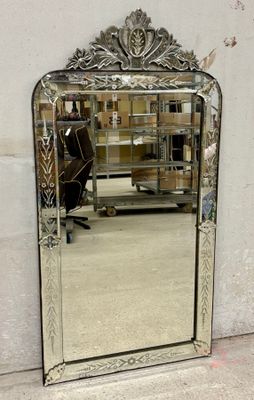 a mirror that is sitting on the floor in front of a wall