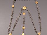 rosary chain with a cross and coins on it on a table