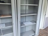 two open shelves in the corner of a room