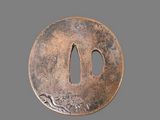 a close up of a round metal object on a gray surface