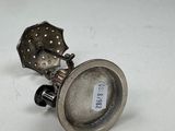 a silver object that is sitting on a white surface