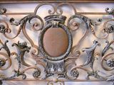 a picture of a decorative iron fence with a picture on it