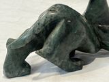 a statue of a woman laying down on a white surface