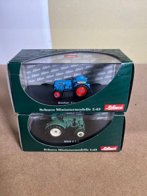 the box is open on the table with a toy tractor in it
