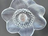 a close up of a glass flower on a table
