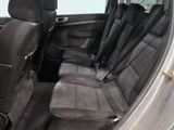 the back seats of a silver car with a black seat belt