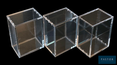 three clear boxes sitting next to each other on a black background