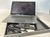 a laptop computer sitting in a box with a charger