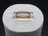 a close up of a gold ring with diamonds on it