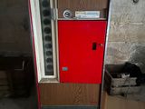 a coca cola machine that is sitting in a room
