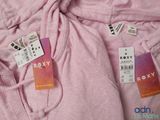 a pink hoodie with two tags attached to it