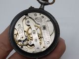 a close up of a pocket watch being held in someone ' s hand