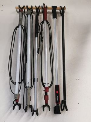 a bunch of tools hanging on the wall next to each other