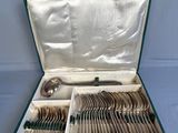silverware in a green case on a blue background