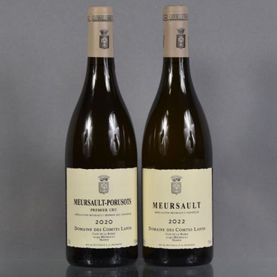 two bottles of wine sitting on top of a table next to each other