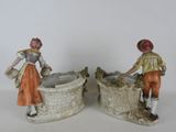 pair of figurines of a man and a woman standing next to each other