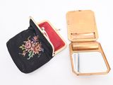 a small gold purse with a mirror and a black bag