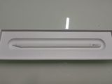 a white box with a pen in it on a table