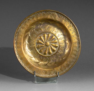 a close up of a gold plate with a flower design on it