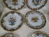 four plates with different designs on them sitting on a table