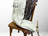 an image of a white leather jacket and pants on a chair