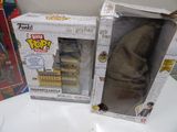 two harry potter toys are sitting on a table next to each other