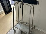 a metal cart with a black seat in a room