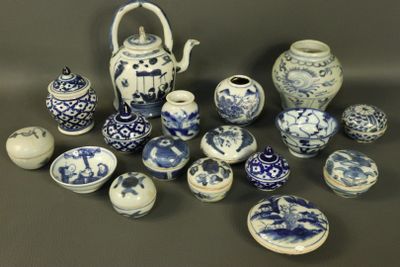 many blue and white vases and bowls on the table