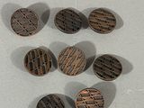 several metal buttons are arranged on a white surface
