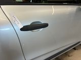 a close up of a car door handle with a sticker on it
