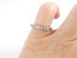 a woman ' s hand with a diamond ring on it