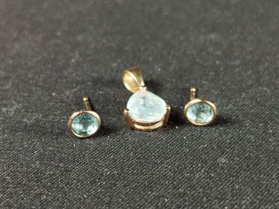 a close up of three pieces of jewelry on a black surface