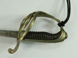 a close up of a sword on a white surface