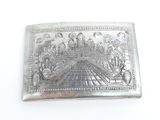 an old silver plate with a picture of a temple on it