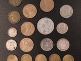 a lot of different coins that are on the table