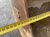 a measuring tape on the side of a piece of metal