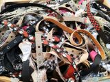 a wooden box filled with lots of different types of belts