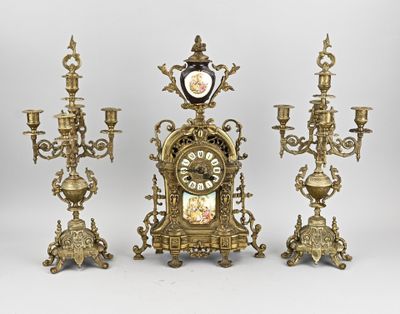 four different types of clocks and candelabs on display