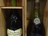 two bottles of wine sitting in a wooden box