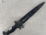 a close up of a knife on a white surface with a black handle
