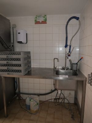 a kitchen with a sink and a refrigerator in it
