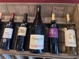 bottles of wine are lined up in a wooden crate