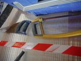a pair of saws and a hand saw on the floor