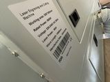a refrigerator that has a label on it in a room