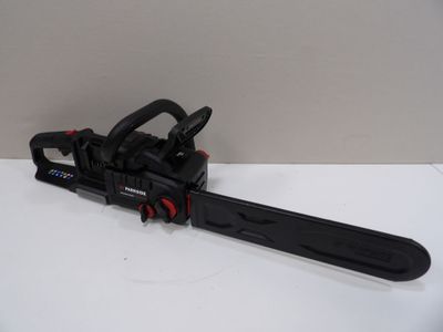 a black and red chainsaw sitting on top of a white table