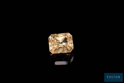 un diamant jaune sur une surface noire