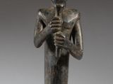 an image of a statue of a man sitting on top of a wooden base