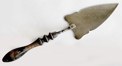 a knife with a handle on a white surface