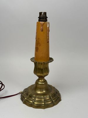 brass plated table lamp with a brown glass shade and a red cord