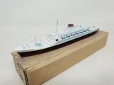 a small model of a cruise ship on a cardboard box